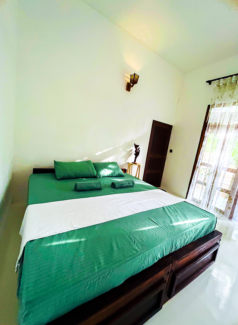 AC room bed with curtained window