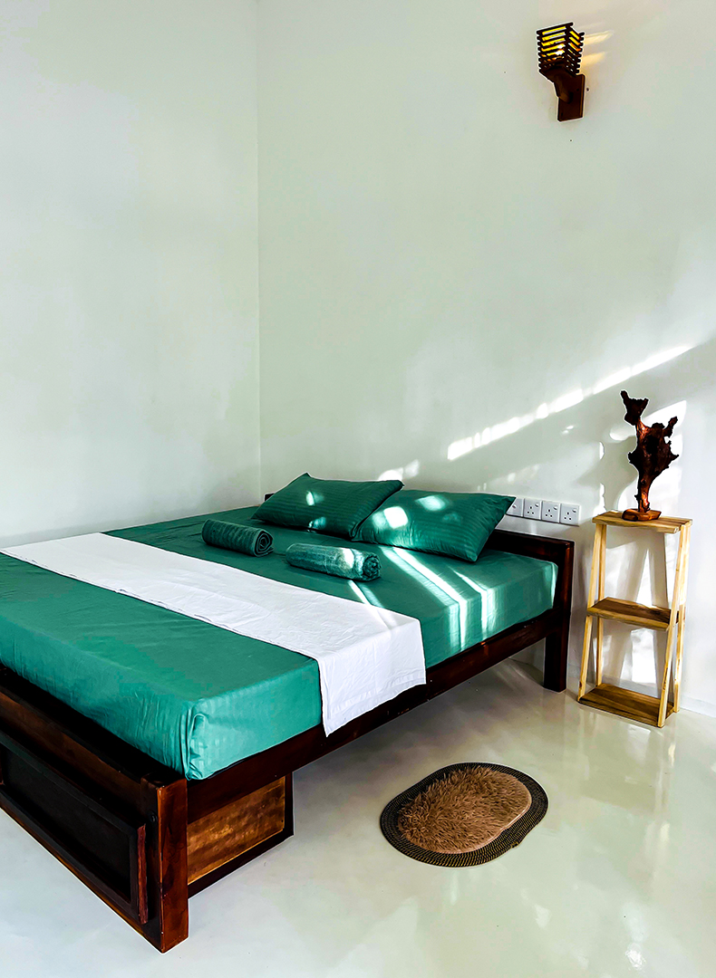 AC room with teak bed and wall sconce light